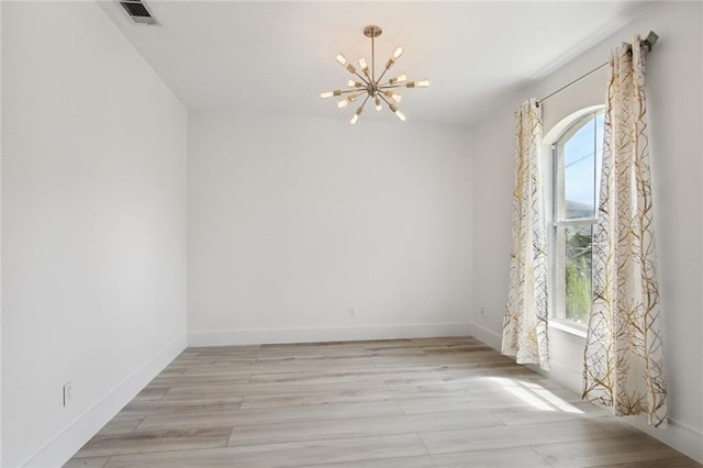 5910 Milne Blvd, New Orleans, LA 70124 - spare room featuring a chandelier and light wood finished floors
