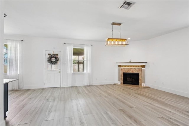 5910 Milne Blvd, New Orleans, LA 70124 - unfurnished living room with healthy amount of natural light, light wood-style floors, and a fireplace