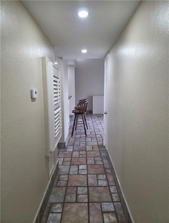 4829 Wabash St Unit 307, Metairie, LA 70001 - hall featuring brick floors, recessed lighting, and a textured wall