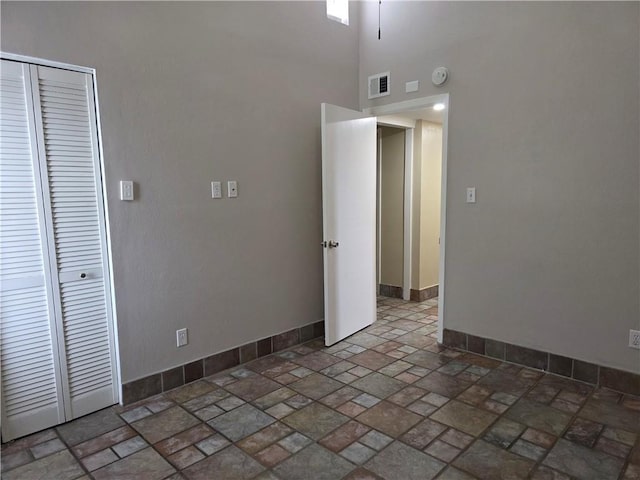 4829 Wabash St Unit 307, Metairie, LA 70001 - spare room featuring stone finish floors and a high ceiling