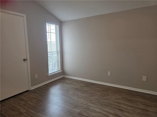 4829 Wabash St Unit 307, Metairie, LA 70001 - spare room with dark wood-style floors and vaulted ceiling