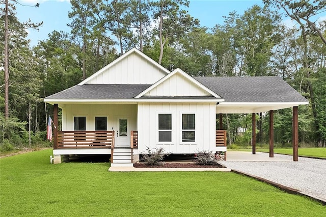 19480 N 3rd St, Covington, LA 70433 - view of front facade with roof with shingles, board and batten siding, a front lawn, and an attached carport
