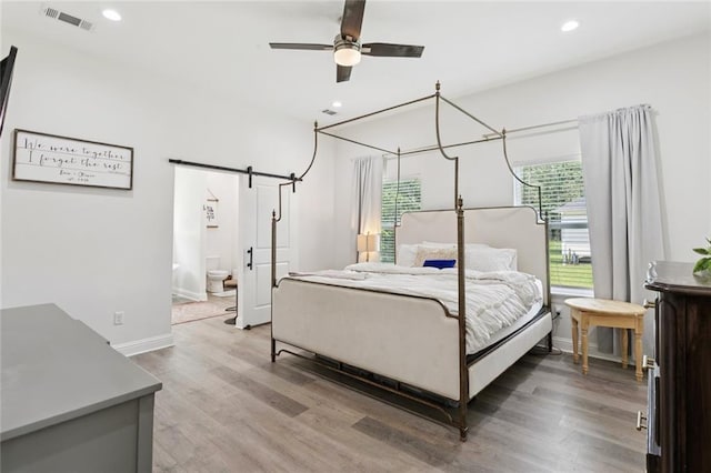 19480 N 3rd St, Covington, LA 70433 - bedroom with light wood finished floors, a barn door, and recessed lighting