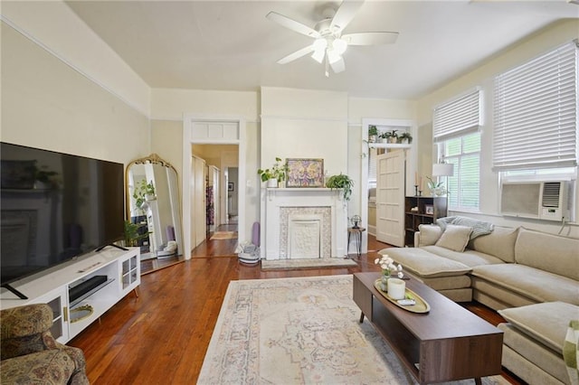113335 Fern St, New Orleans, LA 70118 - living area featuring cooling unit, ceiling fan, a fireplace, and dark wood finished floors