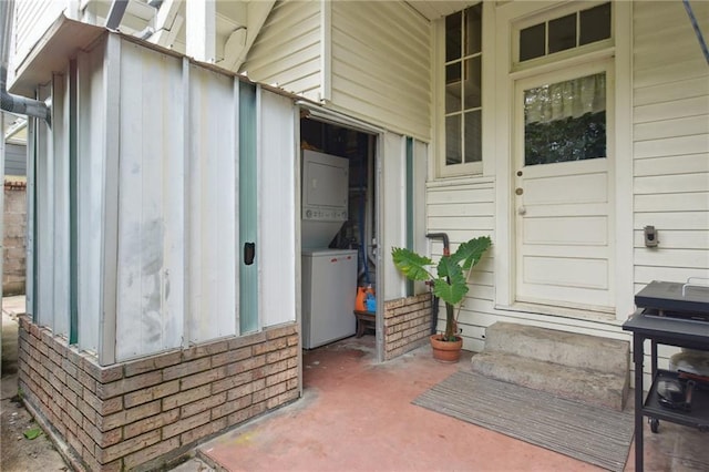 113335 Fern St, New Orleans, LA 70118 - view of exterior entry with stacked washer and clothes dryer and board and batten siding
