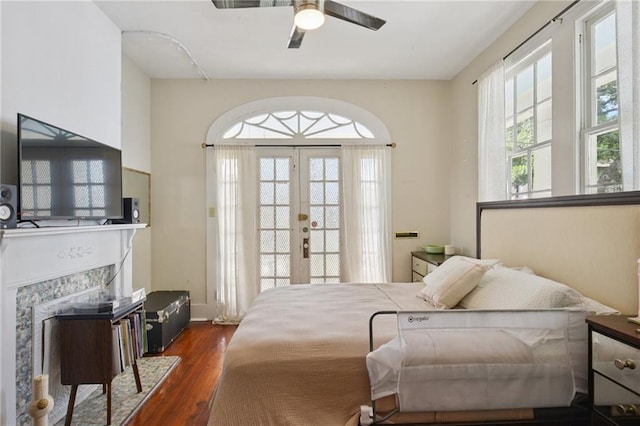 113335 Fern St, New Orleans, LA 70118 - bedroom with access to outside, dark wood finished floors, french doors, a fireplace, and a ceiling fan