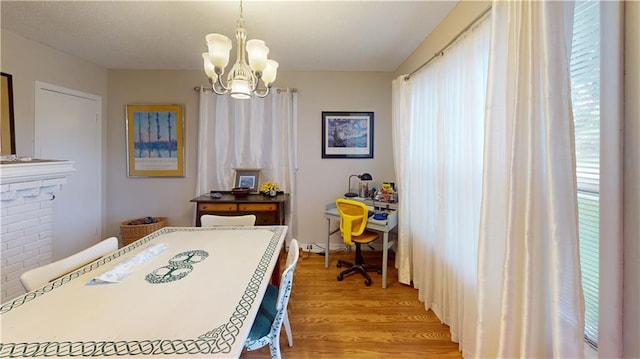 3229 Hero Dr, Gretna, LA 70053 - dining room featuring light wood-type flooring, a chandelier, and healthy amount of natural light