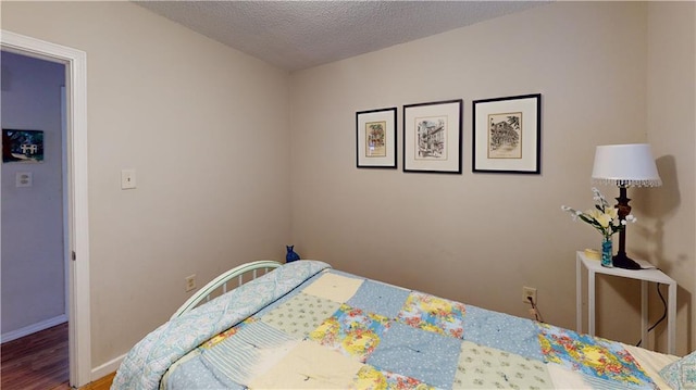 3229 Hero Dr, Gretna, LA 70053 - bedroom featuring wood finished floors and a textured ceiling