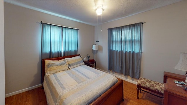 3229 Hero Dr, Gretna, LA 70053 - bedroom with multiple windows and wood finished floors