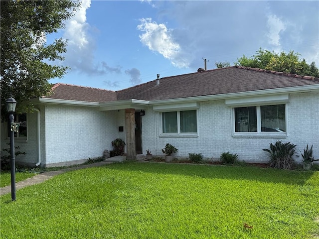 517 Colony Pl, Metairie, LA 70003 - ranch-style home featuring brick siding, a front lawn, and a shingled roof