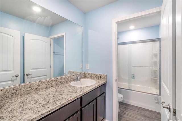 7542 1ST Lake Dr, Slidell, LA 70461 - bathroom with vanity, enclosed tub / shower combo, and wood finished floors