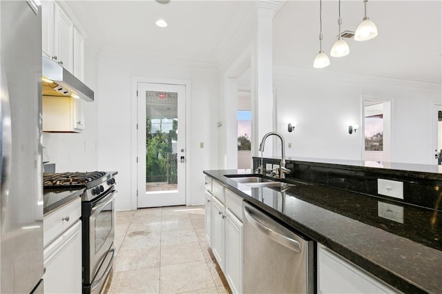 8416 Oak St Unit K, New Orleans, LA 70118 - kitchen featuring appliances with stainless steel finishes, ornamental molding, white cabinetry, under cabinet range hood, and hanging light fixtures