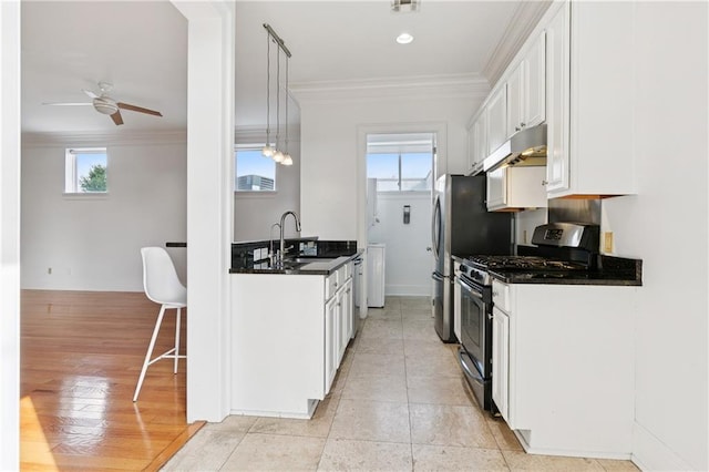 8416 Oak St Unit K, New Orleans, LA 70118 - kitchen featuring stainless steel appliances, under cabinet range hood, ceiling fan, crown molding, and white cabinetry
