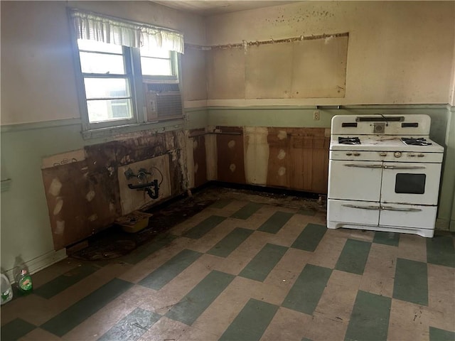 3822 Leila Pl, Jefferson, LA 70121 - kitchen with double oven range, dark flooring, and wainscoting