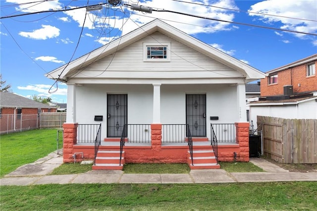 2446 N Rocheblave St, New Orleans, LA 70117 - view of front facade featuring covered porch and stucco siding