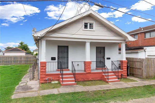 2446 N Rocheblave St, New Orleans, LA 70117 - shotgun-style home featuring covered porch and stucco siding