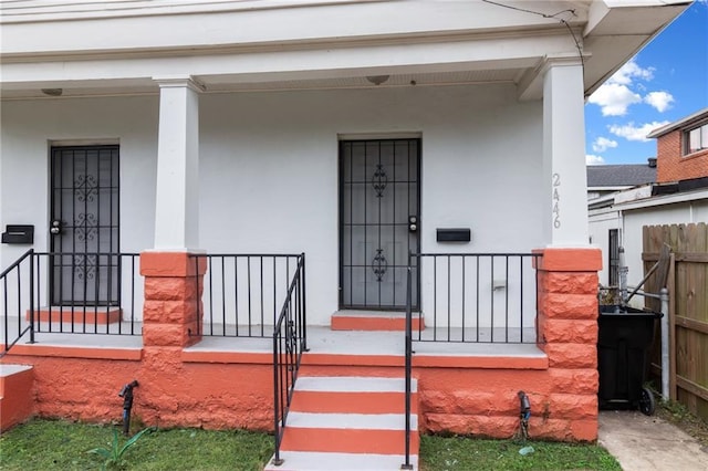 2446 N Rocheblave St, New Orleans, LA 70117 - property entrance with covered porch and stucco siding