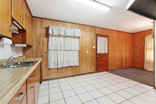 508 Arnold Ave, River Ridge, LA 70123 - kitchen with light countertops, brown cabinets, wood walls, and light colored carpet
