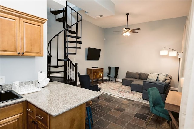 152729 Dumaine St, New Orleans, LA 70116 - living room featuring stairway, a ceiling fan, and dark stone finish floors