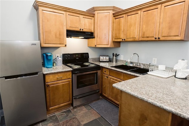 152729 Dumaine St, New Orleans, LA 70116 - kitchen with freestanding refrigerator, range with electric stovetop, under cabinet range hood, stone finish flooring, and brown cabinetry
