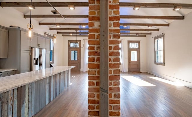623-25 Louisa St, New Orleans, LA 70117 - kitchen with stainless steel refrigerator with ice dispenser, gray cabinets, light wood finished floors, beamed ceiling, and light stone counters