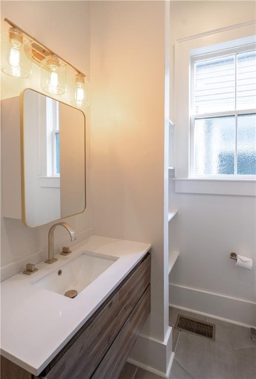 623-25 Louisa St, New Orleans, LA 70117 - bathroom featuring healthy amount of natural light, vanity, and tile patterned flooring