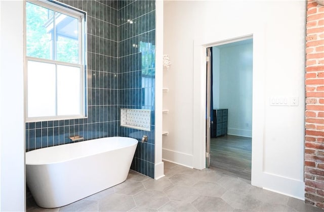 623-25 Louisa St, New Orleans, LA 70117 - full bath with a freestanding bath and tile patterned flooring