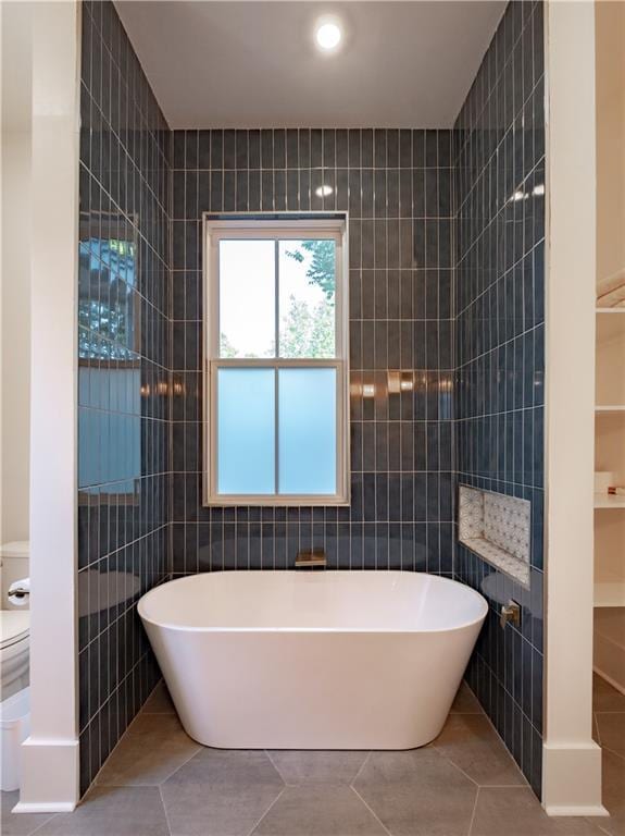 623-25 Louisa St, New Orleans, LA 70117 - bathroom with tile walls, a freestanding bath, and tile patterned flooring