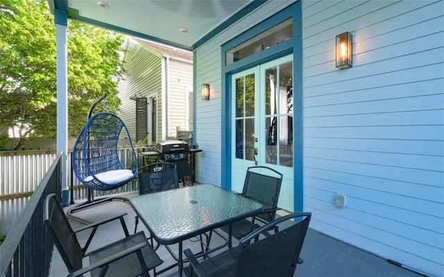 623-25 Louisa St, New Orleans, LA 70117 - view of patio with a grill, outdoor dining space, and french doors