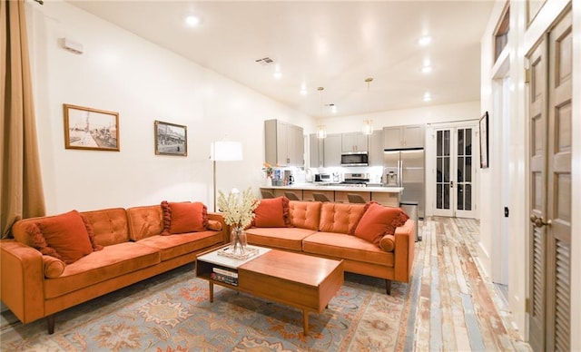 623-25 Louisa St, New Orleans, LA 70117 - living room with light wood-type flooring and recessed lighting