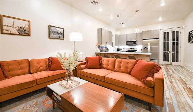 623-25 Louisa St, New Orleans, LA 70117 - living room with french doors, light wood-style flooring, and recessed lighting