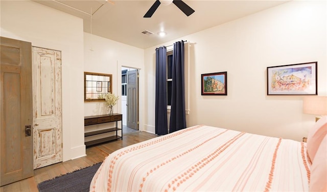 623-25 Louisa St, New Orleans, LA 70117 - bedroom featuring attic access, wood finished floors, and ceiling fan