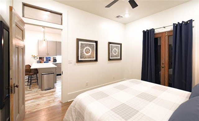 623-25 Louisa St, New Orleans, LA 70117 - bedroom featuring light wood-style floors and a ceiling fan