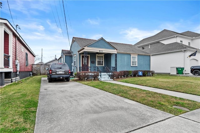 603 E Manley Ave, Metairie, LA 70001 - view of front of property with covered porch, a front lawn, driveway, and stucco siding