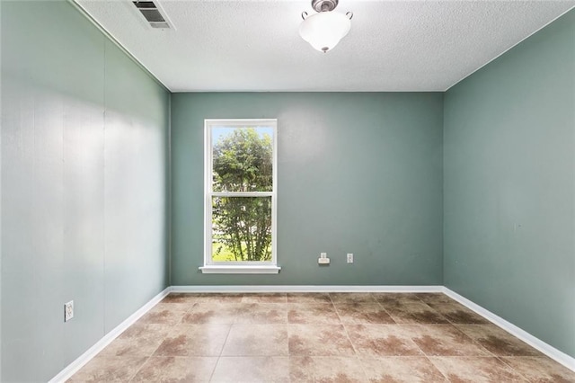 230 Brett Dr, Gretna, LA 70056 - tiled spare room featuring a textured ceiling