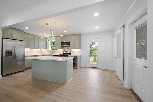 8853 26th St, Metairie, LA 70003 - kitchen with stainless steel appliances, healthy amount of natural light, light wood-style floors, light countertops, and recessed lighting