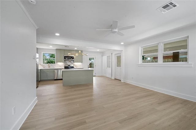 8853 26th St, Metairie, LA 70003 - kitchen with a ceiling fan, crown molding, tasteful backsplash, a center island, and recessed lighting