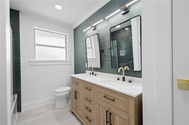 8853 26th St, Metairie, LA 70003 - bathroom with double vanity, ornamental molding, and bathtub / shower combination