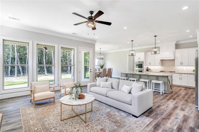 5053 Twin River Pl, Covington, LA 70433 - living area featuring plenty of natural light, crown molding, recessed lighting, wood finished floors, and ceiling fan