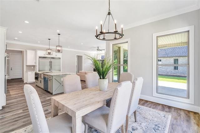5053 Twin River Pl, Covington, LA 70433 - dining area with crown molding, plenty of natural light, wood finished floors, a chandelier, and recessed lighting