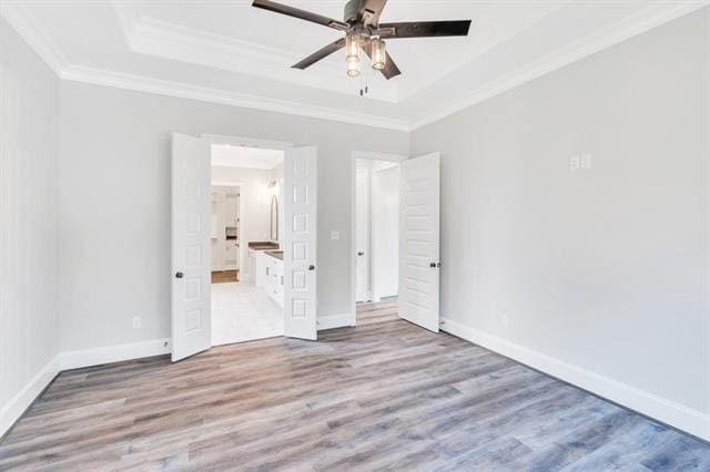 5053 Twin River Pl, Covington, LA 70433 - unfurnished bedroom with a raised ceiling, crown molding, wood finished floors, and ceiling fan