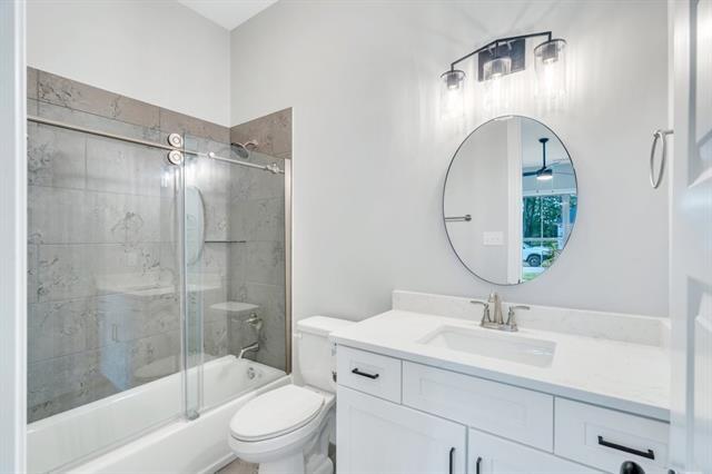 5053 Twin River Pl, Covington, LA 70433 - bathroom with vanity and enclosed tub / shower combo