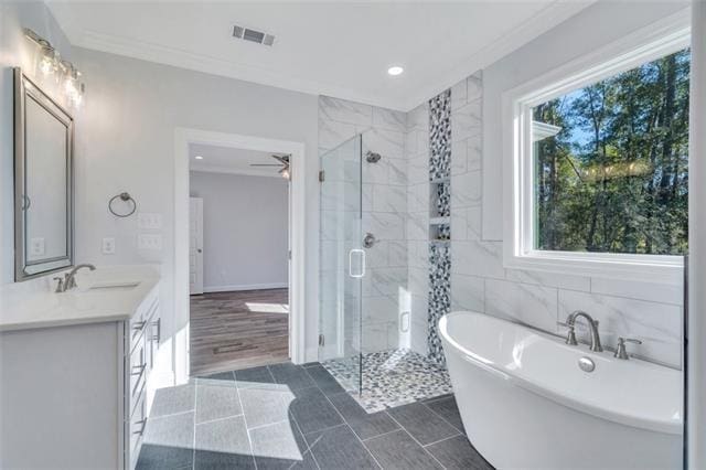 5028 Twin River Pl, Covington, LA 70433 - bathroom featuring a soaking tub, a shower stall, double vanity, ornamental molding, and recessed lighting