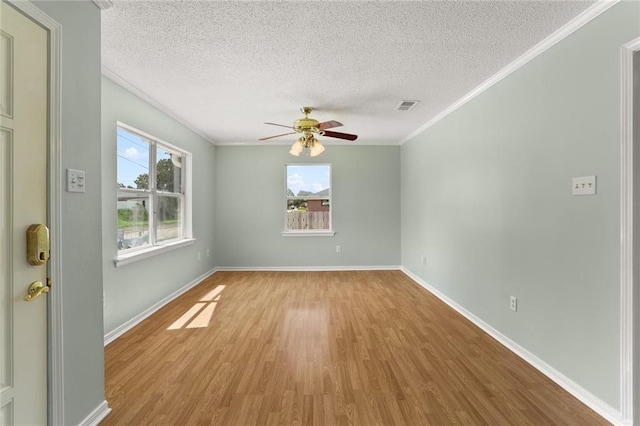 1403 W First St, Belle Chasse, LA 70037 - spare room with light wood-type flooring, crown molding, a textured ceiling, and ceiling fan