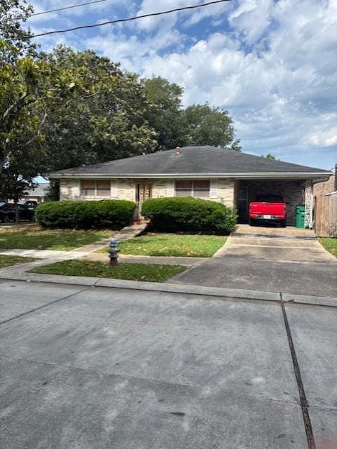 305 Lilac St, Metairie, LA 70005 - view of front facade featuring driveway and a carport