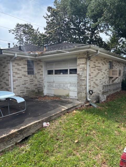 305 Lilac St, Metairie, LA 70005 - view of side of property with an attached garage, brick siding, driveway, and cooling unit