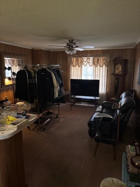 305 Lilac St, Metairie, LA 70005 - living area with wood walls, a textured ceiling, carpet, ornamental molding, and a ceiling fan