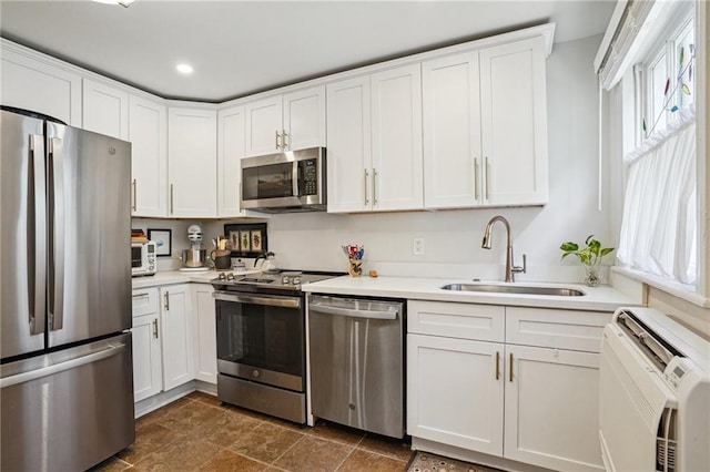 618-24 Fern St, New Orleans, LA 70118 - kitchen with appliances with stainless steel finishes, white cabinetry, light countertops, dark stone finish floors, and recessed lighting