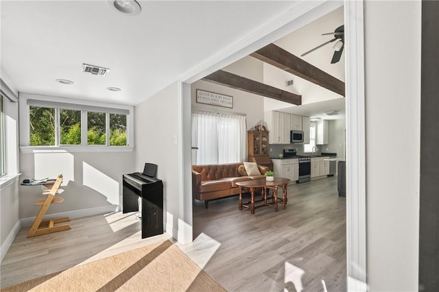 59246 Cypress Bayou Ln, Lacombe, LA 70445 - living area with light wood finished floors and a ceiling fan