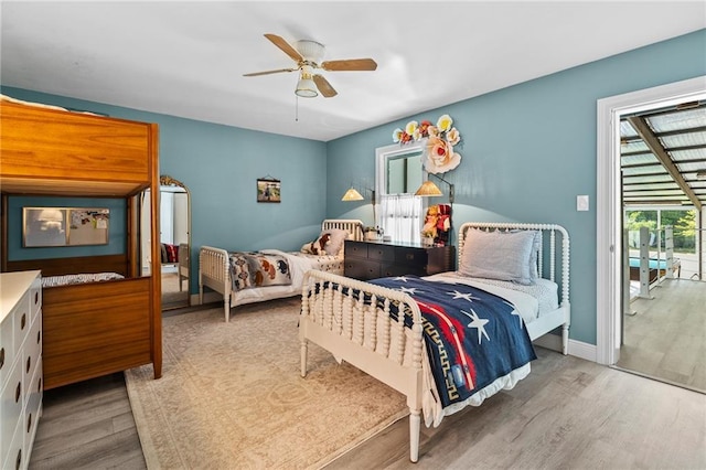 59246 Cypress Bayou Ln, Lacombe, LA 70445 - bedroom featuring wood finished floors, access to outside, and a ceiling fan
